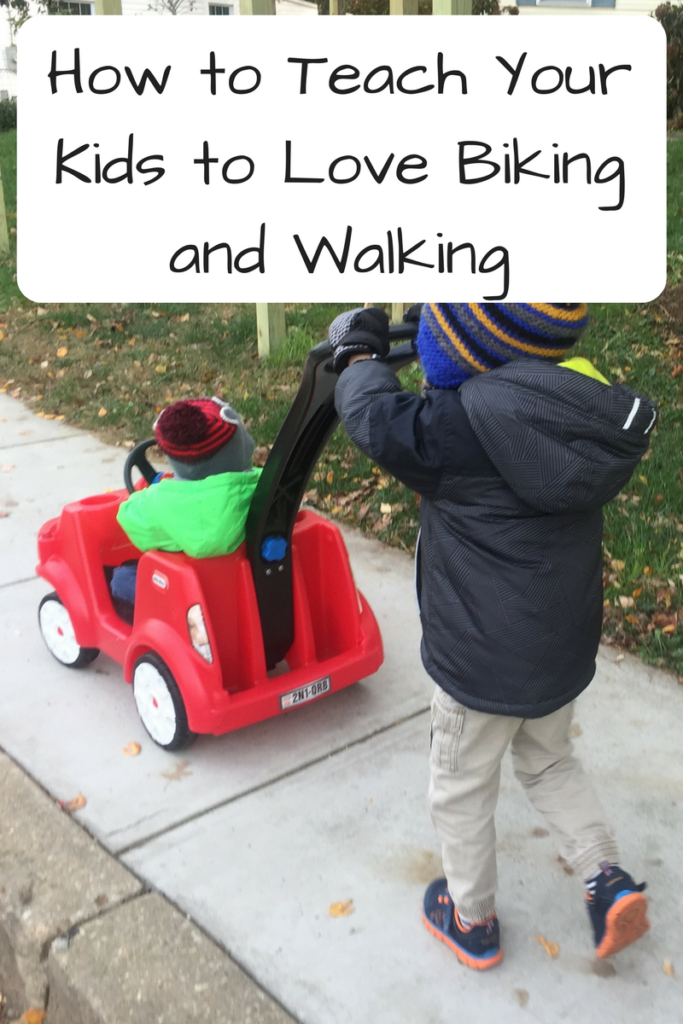 How to Teach Your Kids to Love Biking and Walking (Photo: One little kid pushing another in a little pretend car)