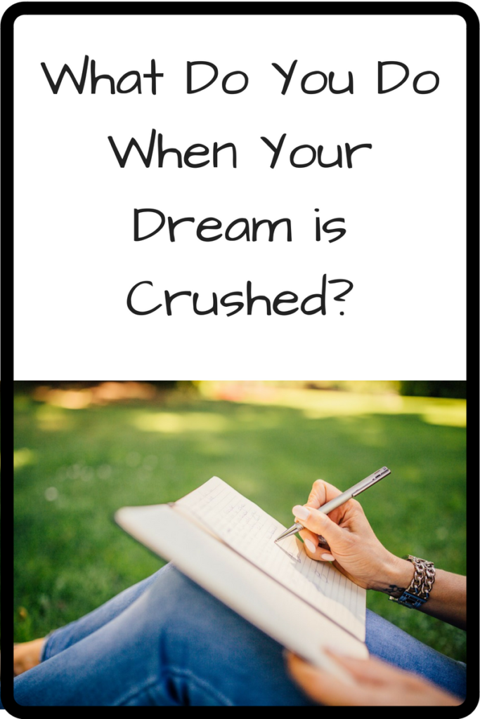 What Do You Do When Your Dream is Crushed? (Photo: Hand of a person writing in a journal while they are sitting on grass)