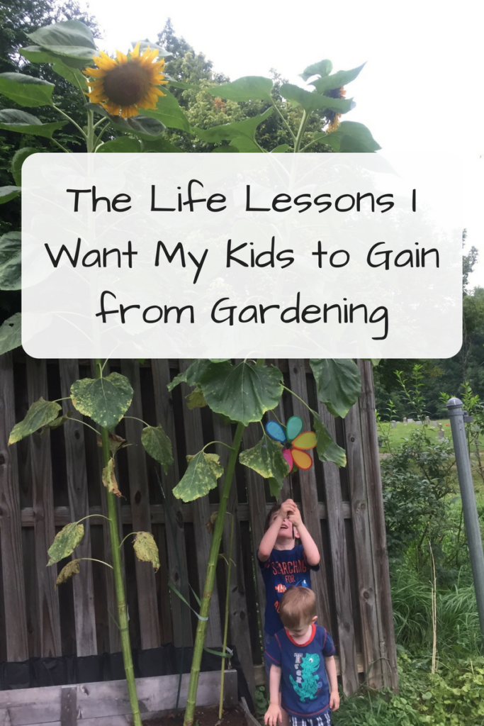 The Life Lessons I Want My Kids to Gain from Gardening (Photo: Two young white children standing in front of giant sunflowers)