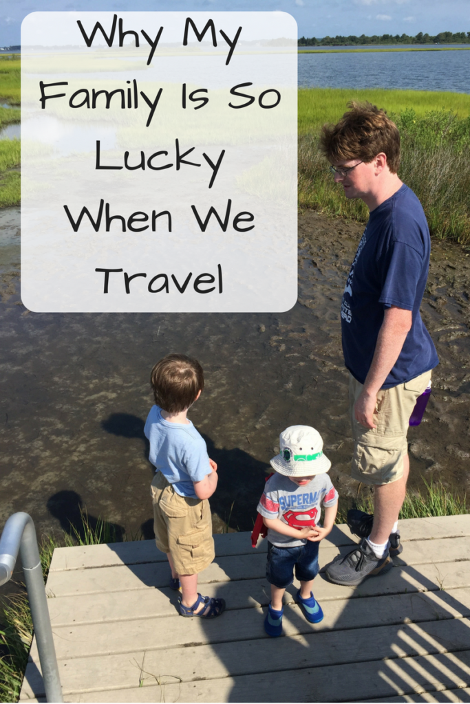 Why My Family Is So Lucky When We Travel (Photo: White man and two children standing on a boardwalk in front of a mud flat)