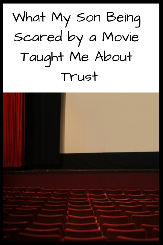Photo: Old-fashioned theater seats in front of a stage with a movie screen; Text: What My Son Being Scared by a Movie Taught Me About Trust