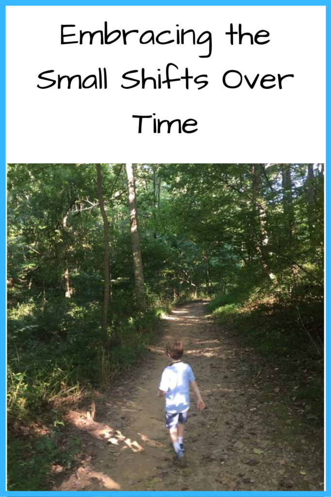 Text: Embracing Small Shifts Over Time; Photo: Young white boy walking down a forest path