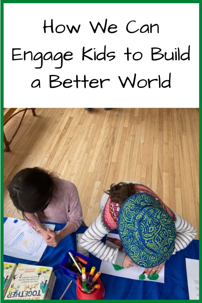 How We Can Engage Kids to Build a Better World; Image description: Photo of two white girls with dar hair leaning over a table with a blue tablecloth, drawing pictures in marker, with the book Growing Sustainable Together above the paper
