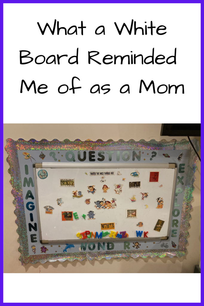 What a White Board Reminded Me of as a Mom - photo of a white board with the words Question? Imagine Wonder and Explore around it with Where the Wild Things Are and alphabet magnets on it