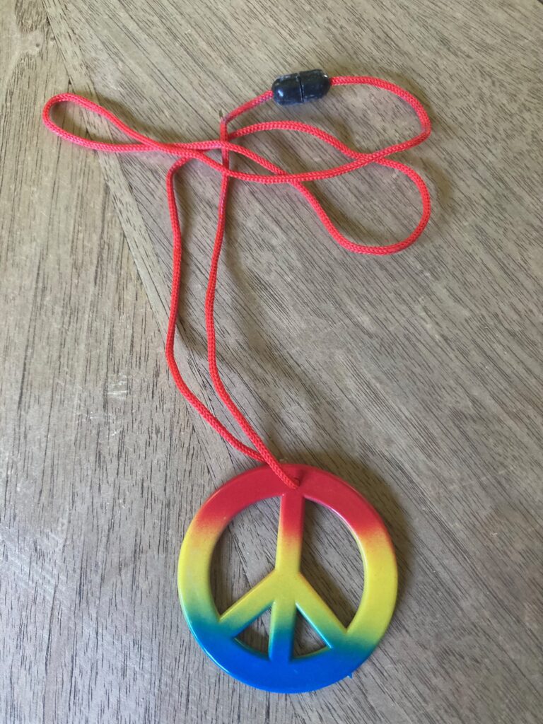 A necklace with rainbow peace sign pendant