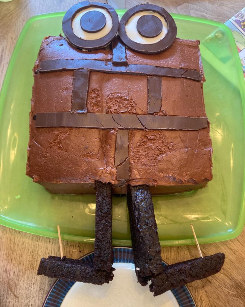 A cake of a brick with big cartoon eyes and legs