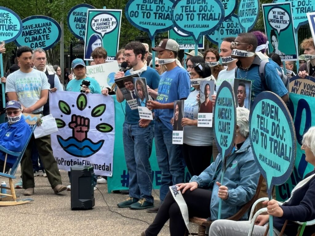 A group of young protestors holding signs about the Juliana vs. U.S. court case